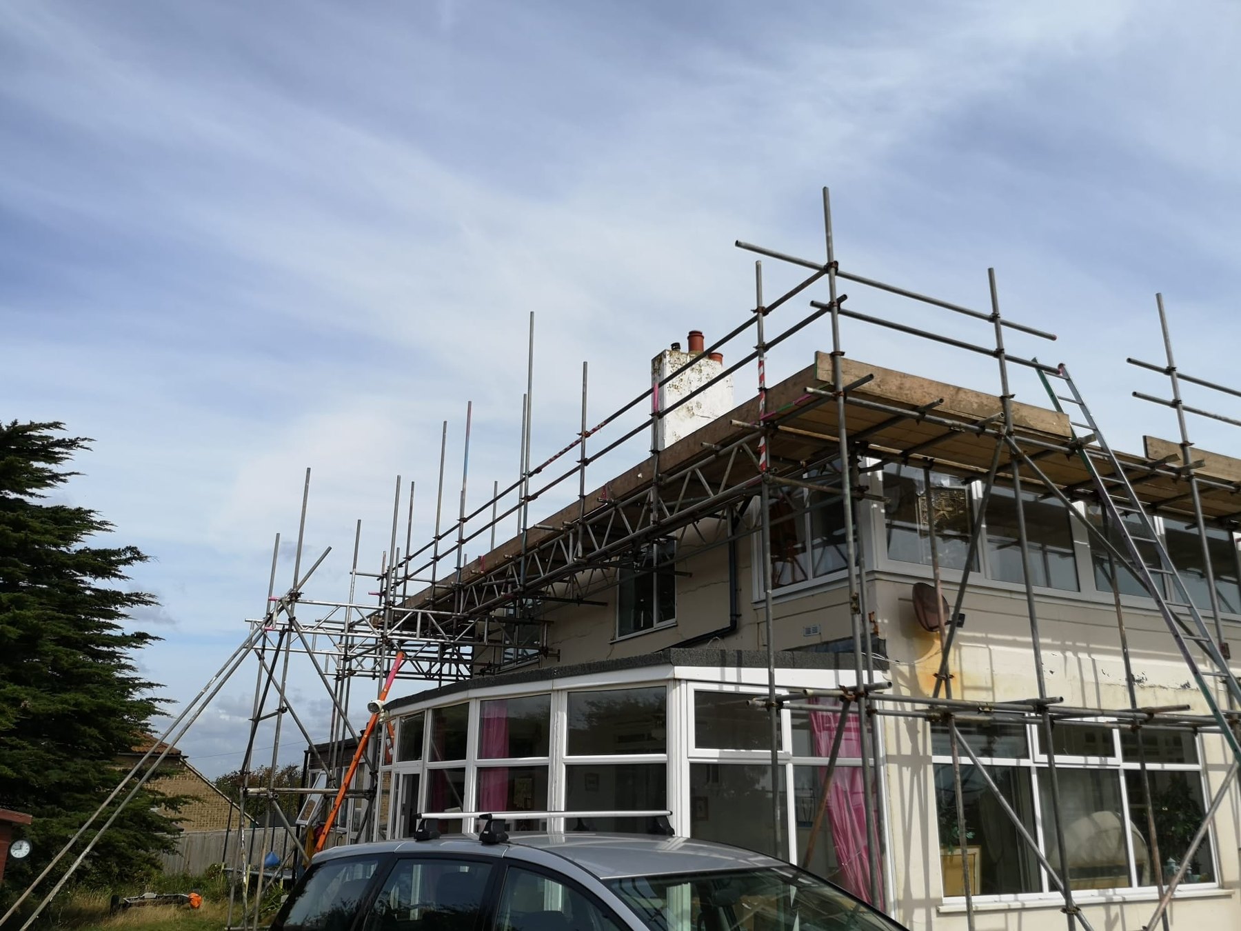 Scaffold over a conservatory giving access to the roof