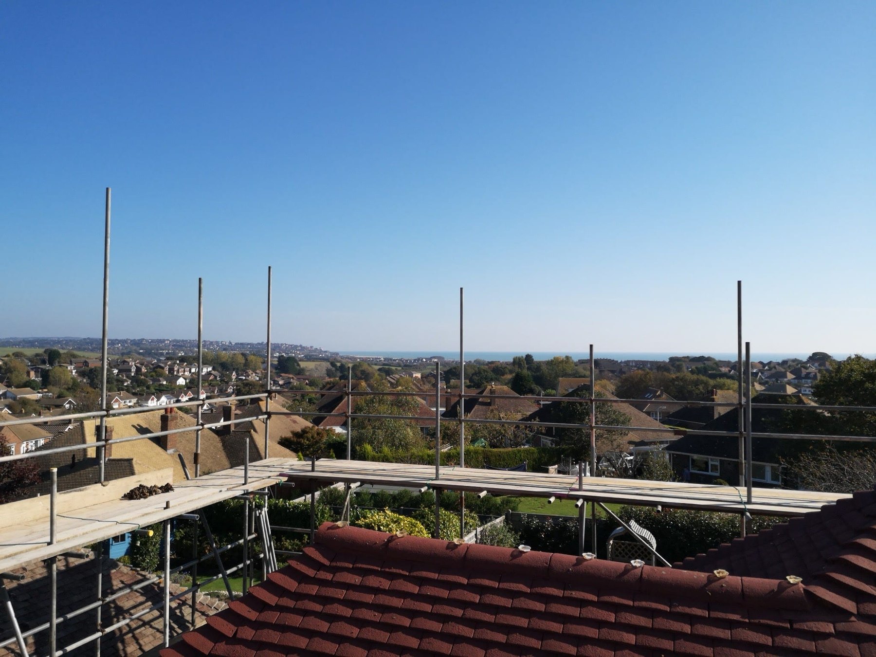 View from a scaffold lift over Hastings rooftops to the sea