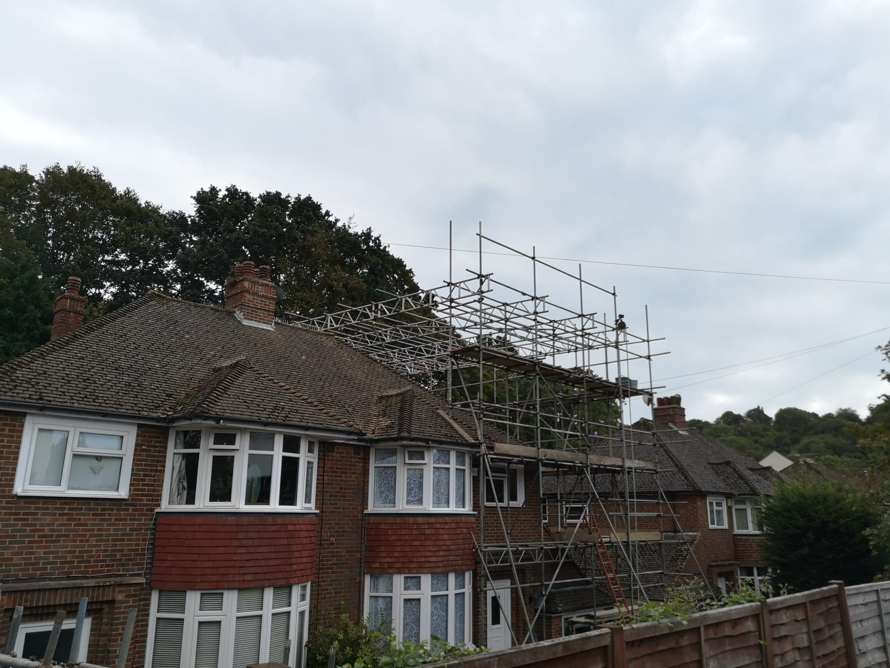 Temporary roof scaffold over a brick terrace
